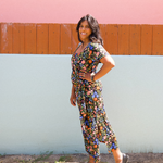 Woman wearing garden-floral jersey midi dress with side tie and square scoop neckline