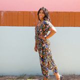 Woman wearing garden-floral jersey midi dress with side tie and square scoop neckline