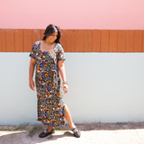Woman wearing garden-floral jersey midi dress with side tie and square scoop neckline