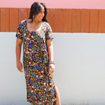 Woman wearing garden-floral jersey midi dress with side tie and square scoop neckline