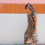 Woman wearing garden-floral jersey midi dress with side tie and square scoop neckline