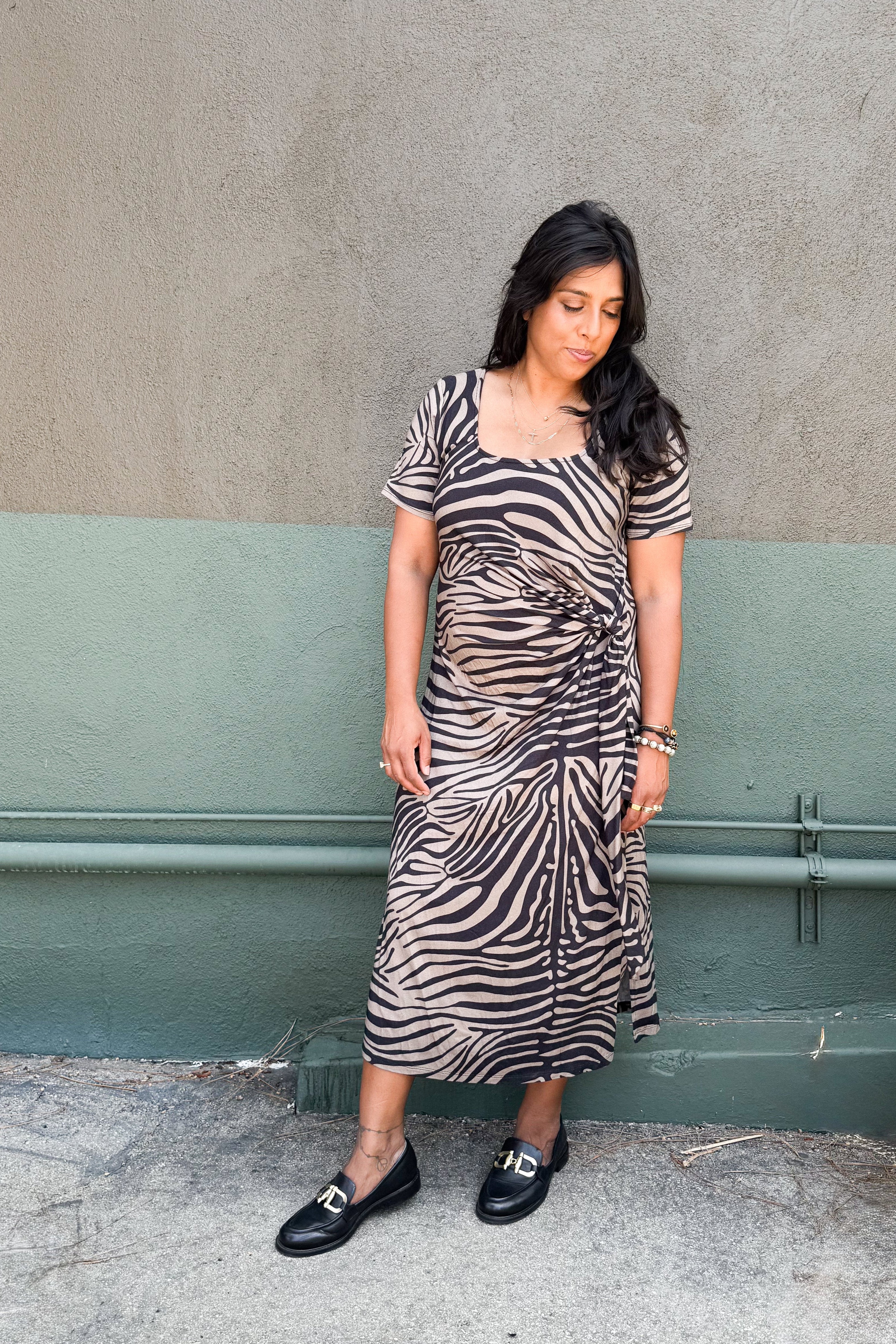 Model in zebra-print jersey midi dress featuring a side tie and two hem slits