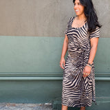 Model in zebra-print jersey midi dress featuring a side tie and two hem slits