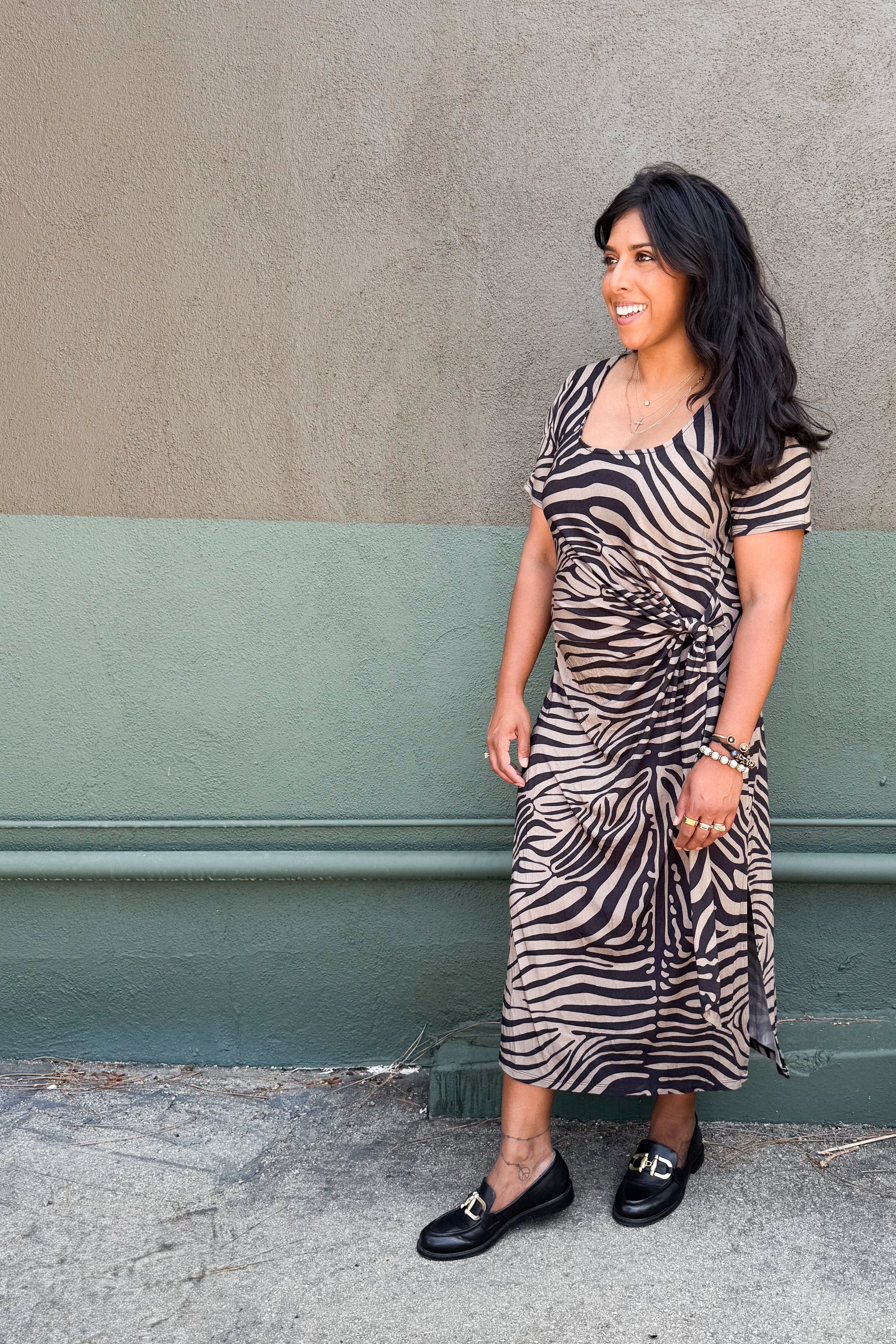 Model in zebra-print jersey midi dress featuring a side tie and two hem slits