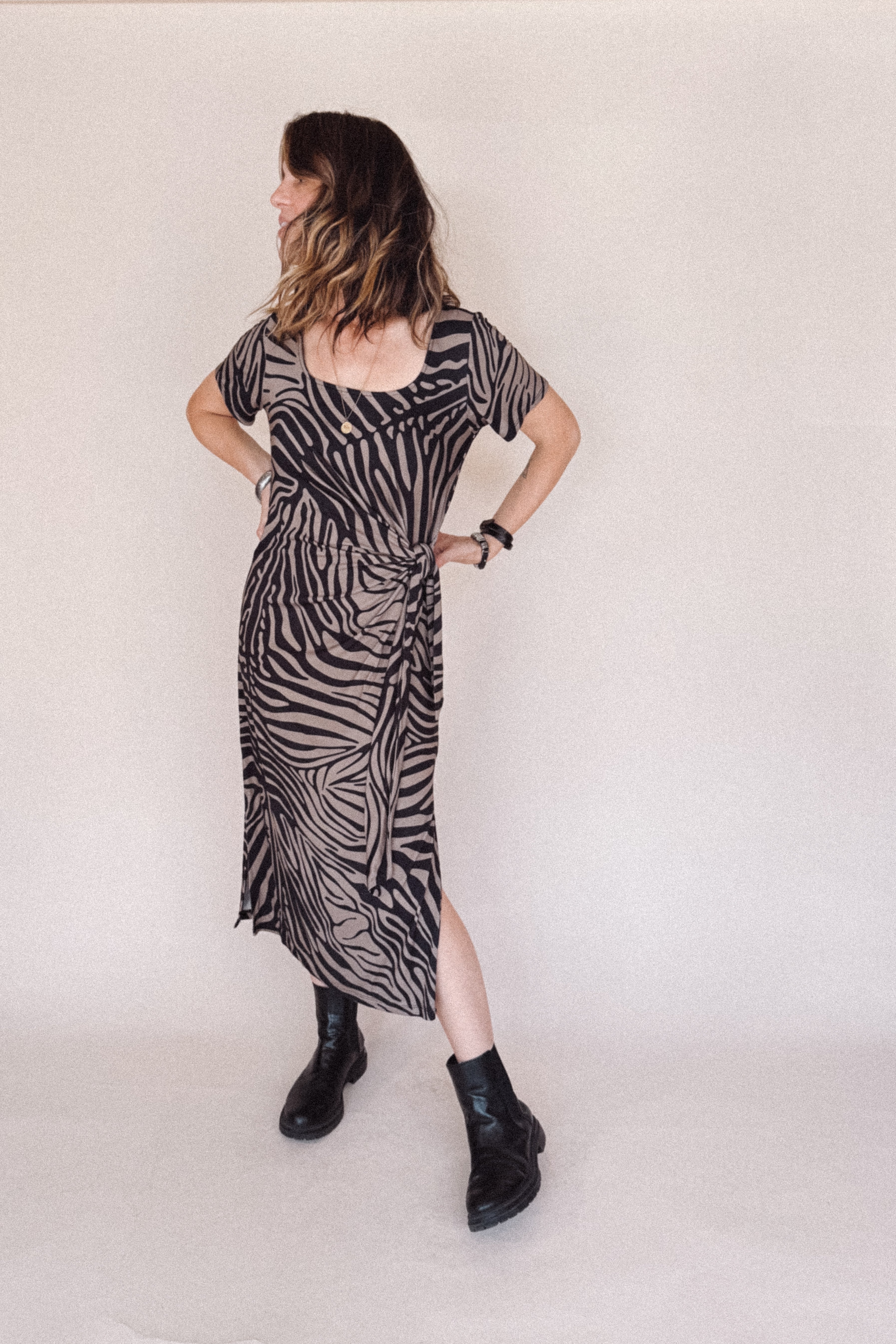 Woman wearing a zebra pattern dress on a white background