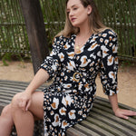 Feel comfortable, confident, and cute in our carefully curated postpartum fashion line, featuring the elegant ANDI adjustable wrap dress.