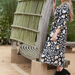 Sustainable fashion for eco-conscious moms: look cute and stay green with the eco-friendly ANDI adjustable wrap dress.