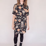 Woman wearing crane-print short sleeve button-up mini shirt dress with collar and side pockets