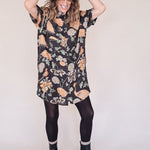 Woman wearing crane-print short sleeve button-up mini shirt dress with collar and side pockets