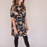 Woman wearing crane-print short sleeve button-up mini shirt dress with collar and side pockets