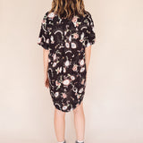 woman wearing euye printed shirt dress back view