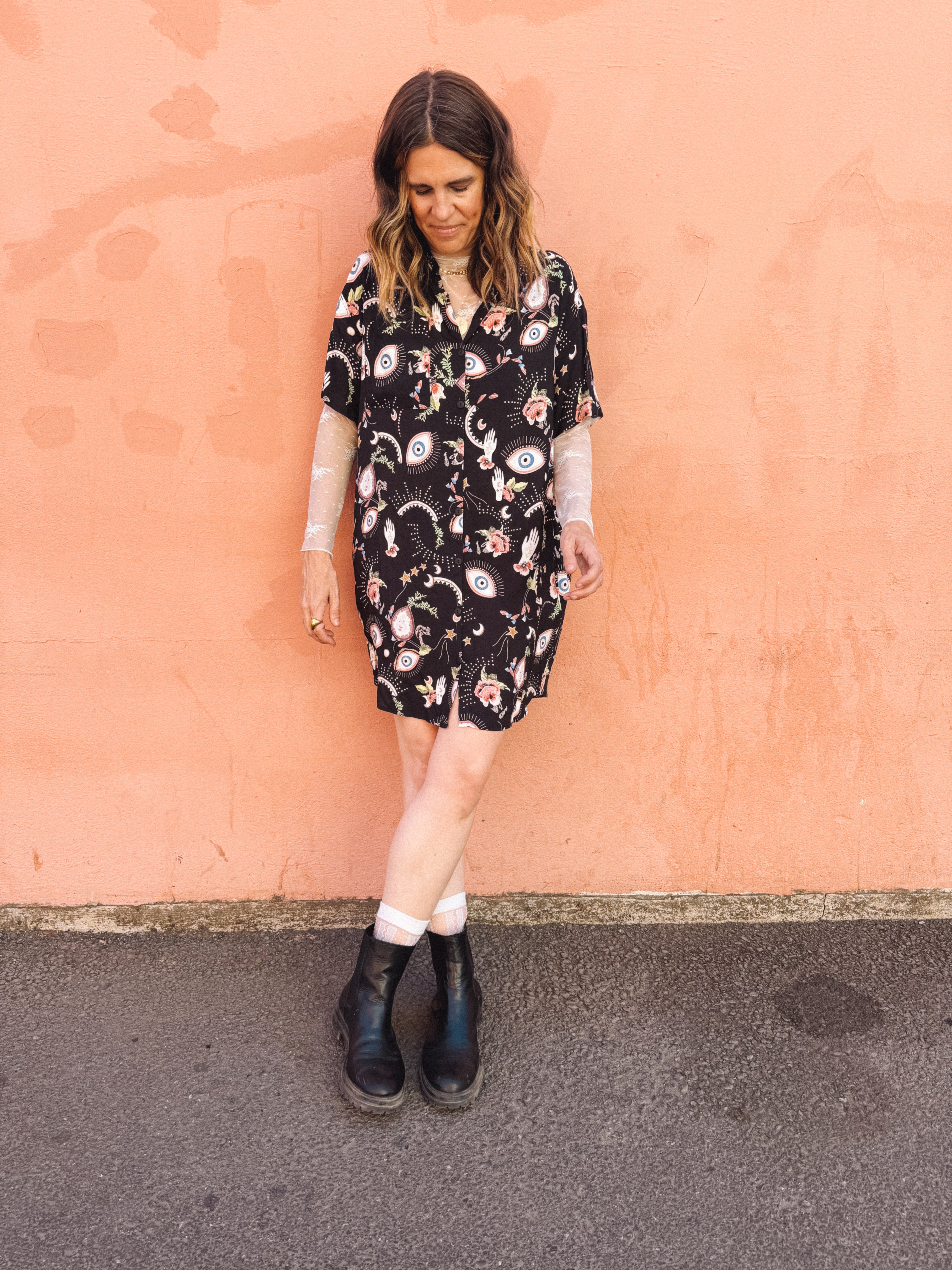 woman wearing mistic eye printed button up mini dress, relaxed shirt dress