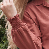 Stay on top of the latest trends in postpartum fashion with the sophisticated ARIA button-up top.