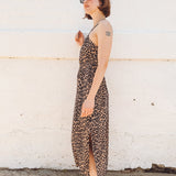 girl with short red hair wearing leopard print midi dress with side slits
